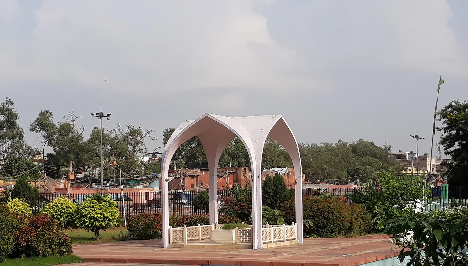 The white arched canopy over the tomb of Maulana Abul Kalam Azad in a garden enclosure in Old Delhi.